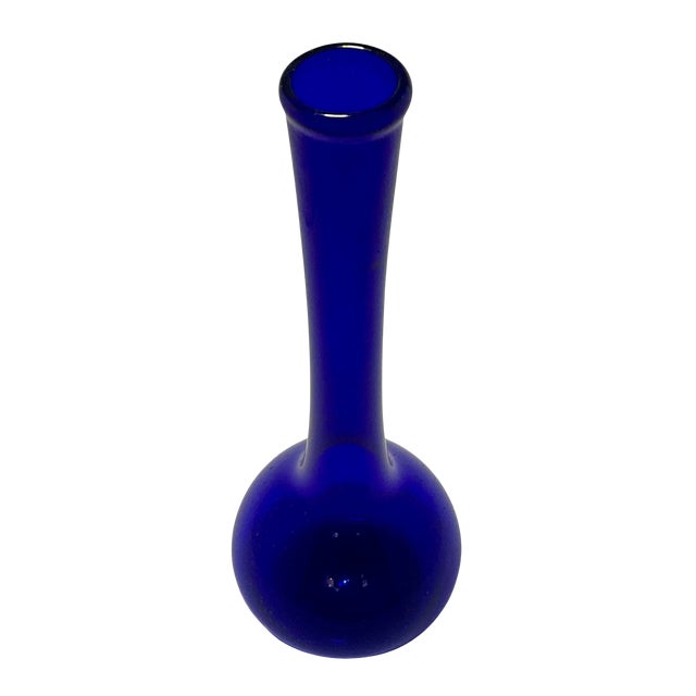 This hand-blown glass vase features a rounded belly and long, slender neck, creating a clean, elegant profile that works...