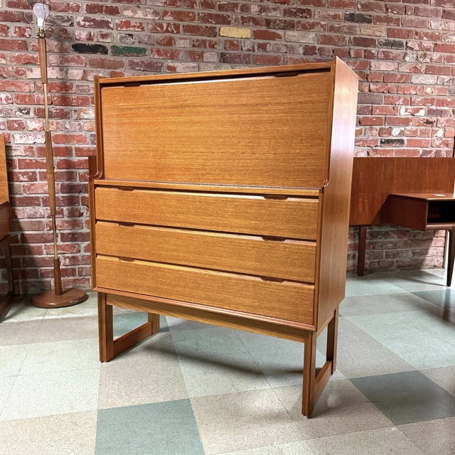 Vintage mid-century modern teak secretary bureau desk produced by Turnidge of London, circa 1970s. Features a drop-front...