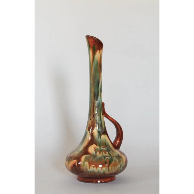 Mid-century drip glaze pottery vessel in earth tones. No makers mark. Minimal signs of age wear.