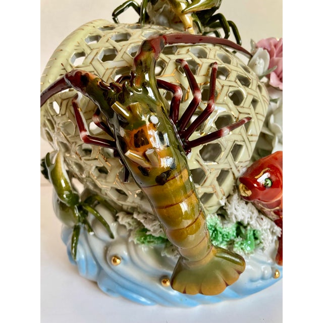 Here is a wonderfully elaborate later mid-century Chinese porcelain sculpture featuring an openwork basket surrounded by...