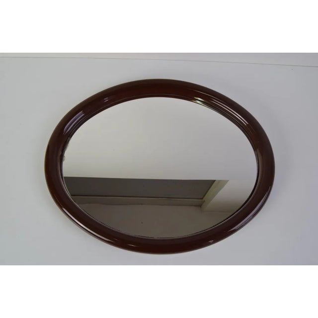 Mirror in a plastic oval frame, can be hung vertically or horizontally. It shows signs of use, there is an aging patina on...