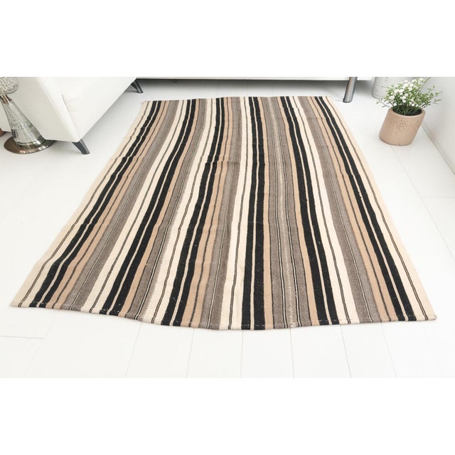 This is a vintage Turkish Oushak rug from the Mid 20th Century. The piece was hand-knotted.