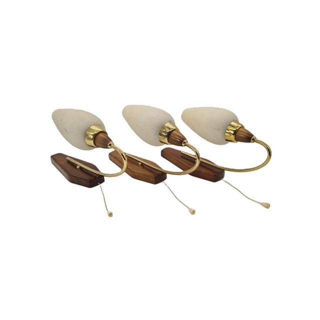 An elegant set of three original wall sconces in the Mid-Century Modern / Scandinavian Modern style from the 1950s and...