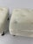 These are super cute bookends that will add style to any shelf! They depict a pair of white tufted seats set on four legs.