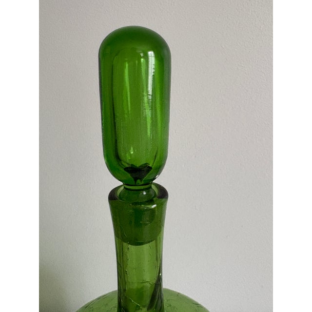 This striking vintage Blenko decanter, designed by renowned American glass artist Joel Philip Myers, is pattern 657M....