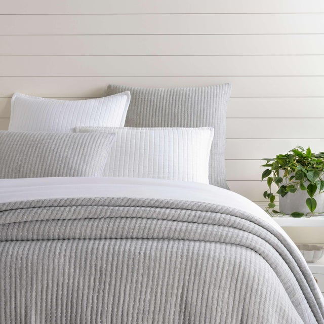 Precisely crafted pick-stitch accentuates the yarn dyed cotton jacquard of this reversible matelassé coverlet and matching...