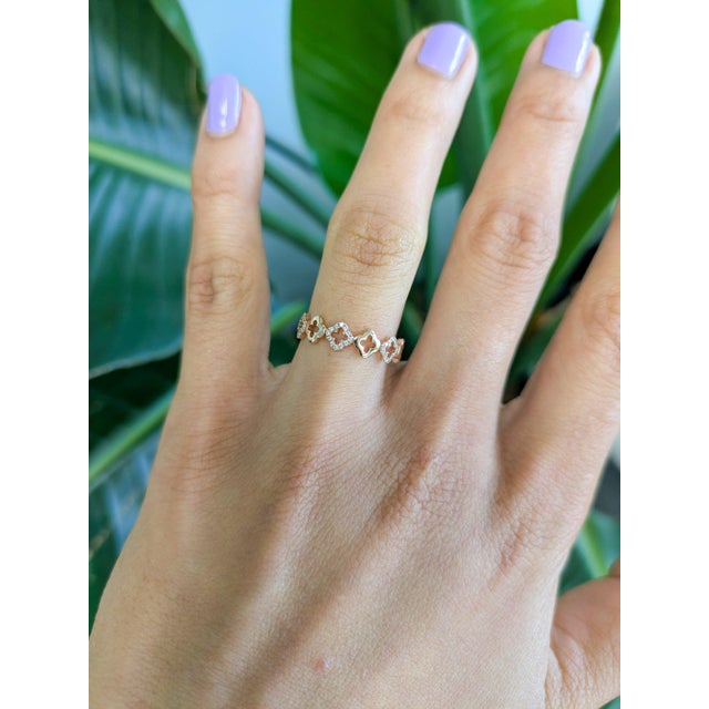 Thirty-six earth-mined diamonds shimmer across this slim solid 14K rose gold band. The warm rose gold flatters the...