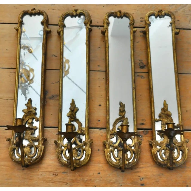 Set of 4 Rococo giltwood and iron mirror back sconces. Two matched pairs. Original gilding and mirror. Wrought iron candle...