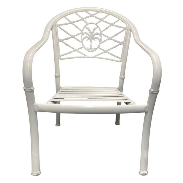 Bring coastal elegance and mid-century resort style to your space with this vintage Hollywood Regency aluminum armchair....