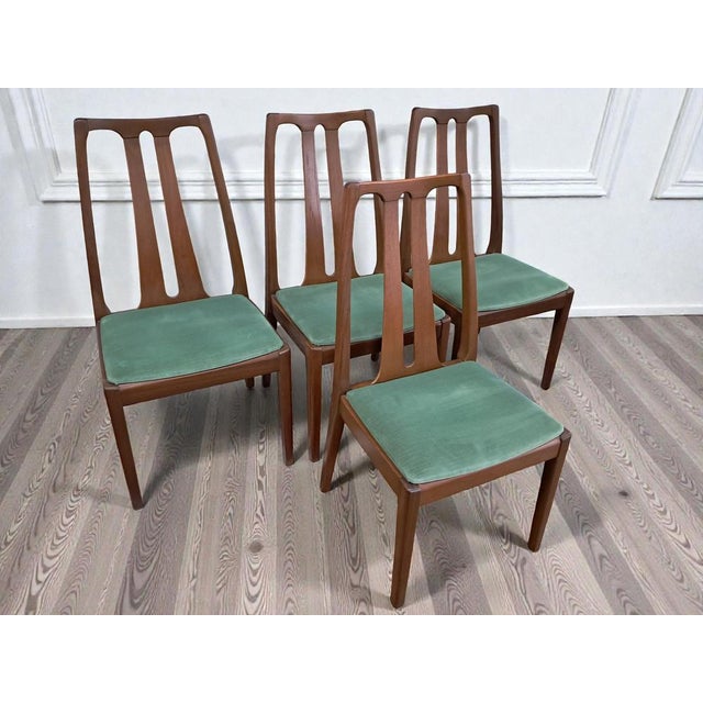 Transform your dining space with this exquisite set of four mid century nathan dining chairs impeccably preserved and in...