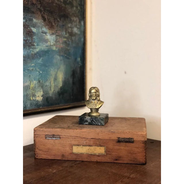 This is vintage, we don’t know the materials for sure. Seems to be heavy for its size, may be brass and stone or marble...