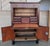 A dramatic Charles X fall front secretary in astounding burled mahogany veneer. The original fossilized marble top is...