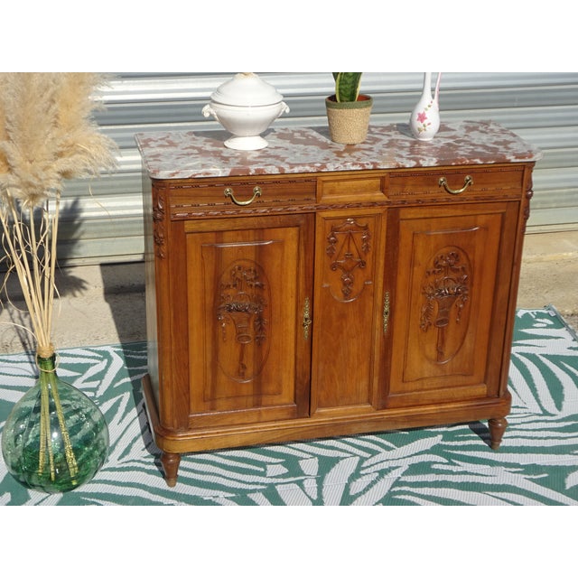 This sideboard, made in France in the early 20th century, blends two styles: the geometric lines of Art Deco and the...