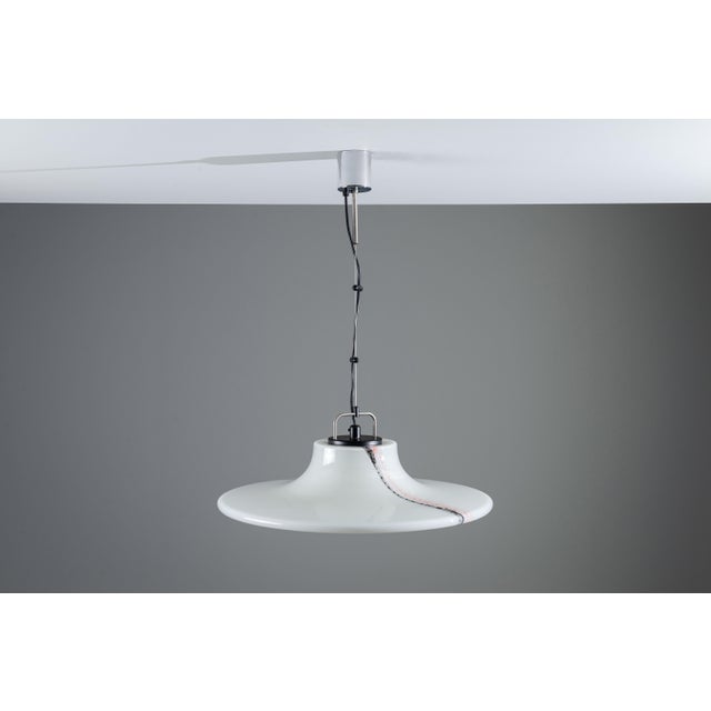 This vintage glass pendant light often referred to as Lido or Cirrus by Peill & Putzler is a refined example of German...