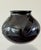 A black glazed earthenware pot. From Mata Ortiz in Northern Mexico. Signed on underside Tomasa Mora. Circa 1990.