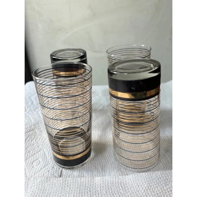 4 vintage black & gold Culver glasses (22 carat gold), 2 3/4" diameter, 5 9/16" high. The glasses are marked Culver and...