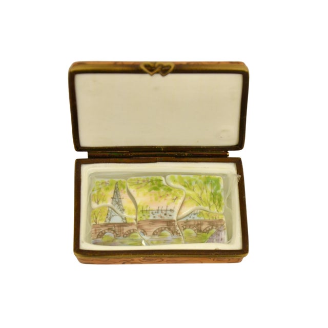 Vintage Limoges of France accent trinket box designed as a colorful Paris scene of bridges over the Seine river and the...