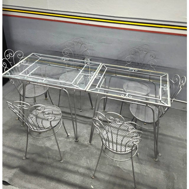 This vintage eight-piece wrought iron outdoor dining set is a stunning addition to any home. The wrought iron material and...