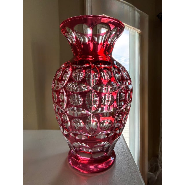 This exquisite piece features a striking ruby red overlay meticulously cut down to a clear layer, showcasing a...