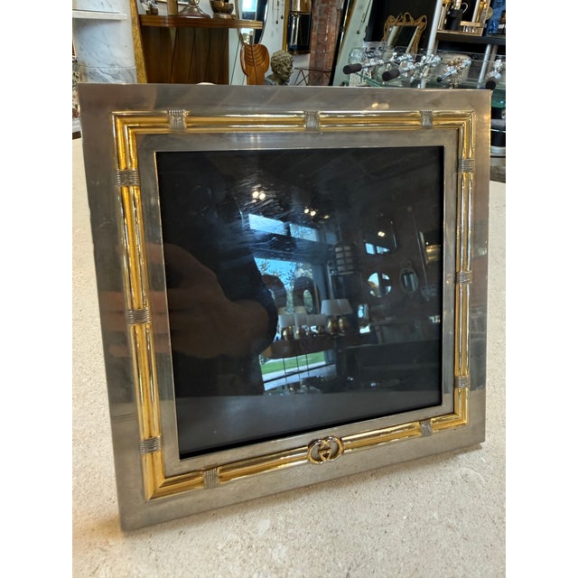 An elegant vintage Gucci picture frame crafted in silver-tone metal with gilt bamboo-inspired detailing along the inner...