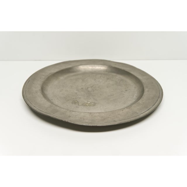 An antique round pewter serving platter or tray. Unmarked.
