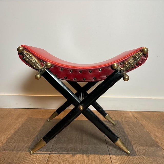 This very beautiful and interesting neoclassical style Curule stool consists of a seat upholstered in red leather, studded...