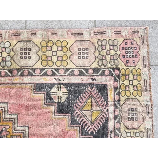 This is a vintage Turkish Oushak rug from the 1960s. The piece was hand-knotted.