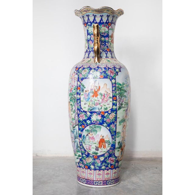 Large Cantonese baluster vase. Features decorated hand-painted polychrome Famille Rose palette with cartouche panels of...