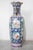 Large Cantonese baluster vase. Features decorated hand-painted polychrome Famille Rose palette with cartouche panels of...