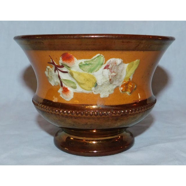 Sweet English copper lustreware bowl with raised fruit decoration against a tan band. Made in the Mid 19th Century.