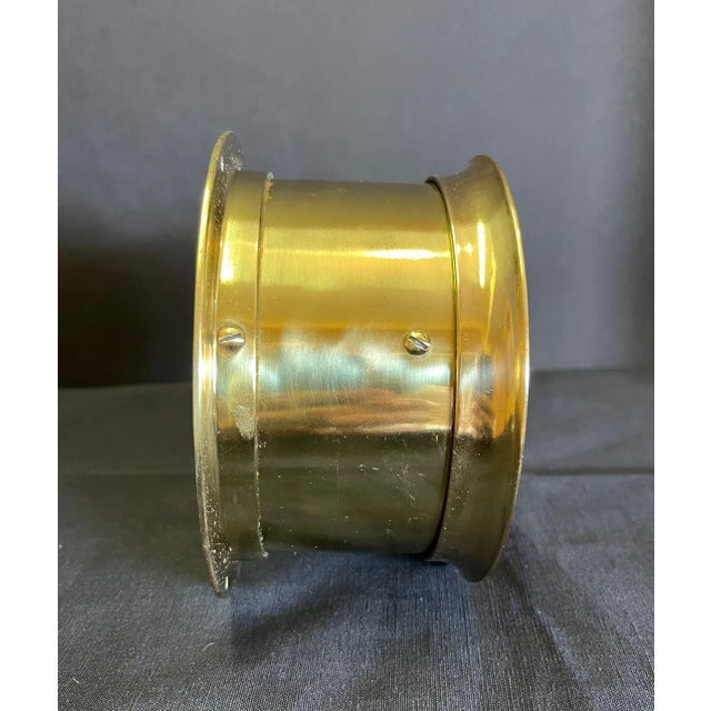 Brass ships clock by Seth Thomas with steel face and black numbers.