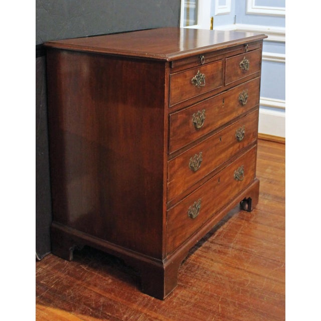 Circa 1765 Georgian period bachelor's chest of drawers, English. Rich mahogany. Brushing slide. Raised on original bracket...