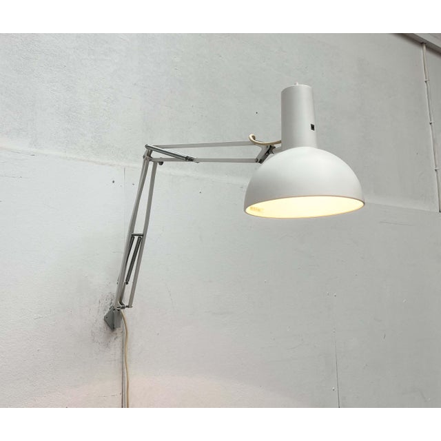 Flexible desk lamp by poulsen, based on a 1972 design. This version is for wall mounting. the it desk lamp is based on the...