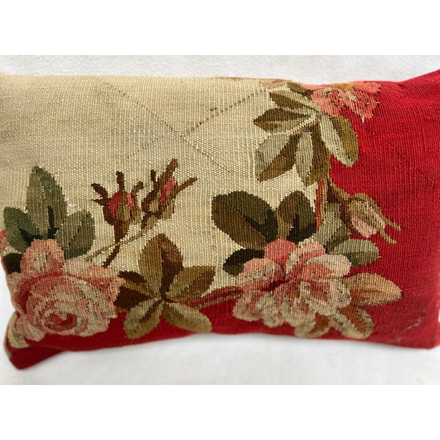 Decorative pillow upholstered in richly woven 19th century Aubusson tapestry, adorned with an elegant floral motif. A...