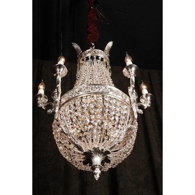 Basket chandelier in BiedermeierClassicist style. Silvered bronze. Basket formed corpus. Adorned with classicist basket-...