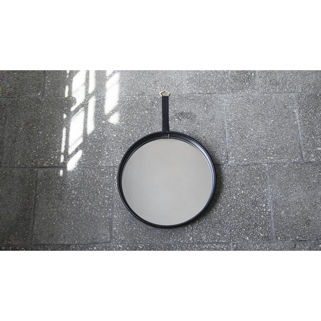 Vintage style round mirror framed in a leather frame - it is both timeless and durable. The wide frame adds depth. This...