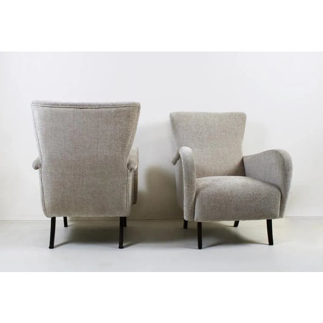 Elegant pair of 1950s vintage armchairs with coeval solid walnut legs and new padding in bouclé cotton fabric. Era:...