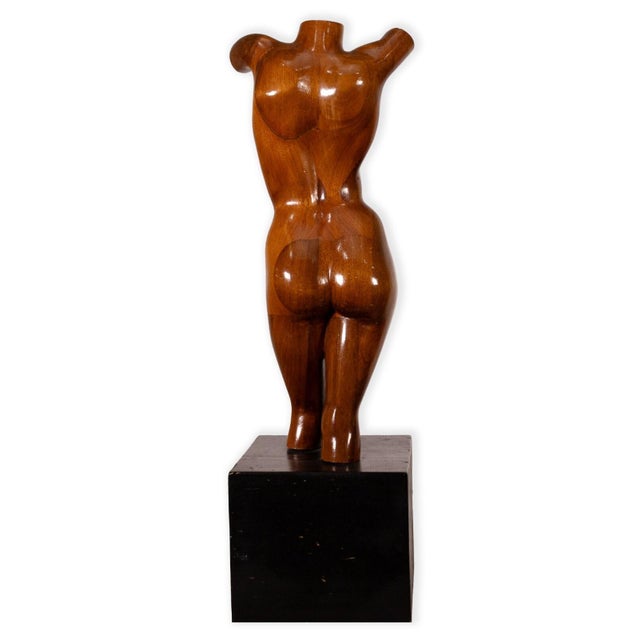 A mid century modern carved female figure bust. This stunning table sculpture features a nude female figure carved from a...