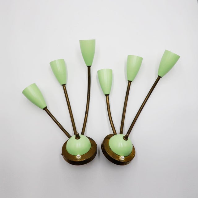 Beautiful pair of mid-century wall sconces from the 1950s. These elegant fixtures stand out for their refined combination...