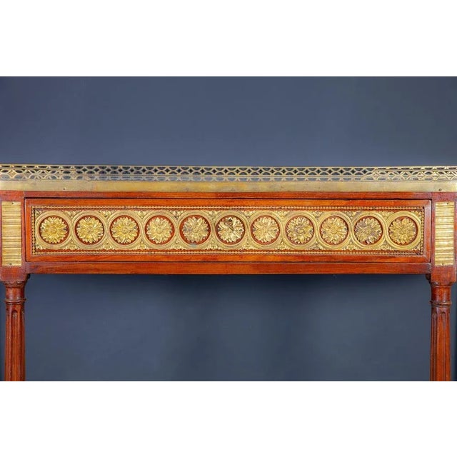 Extraordinary French D-shaped Console Dessert with white statuary marble top adorned with a pierced ormolu gallery. . The...
