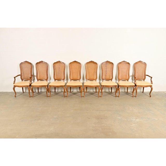A gorgeous set of eight French Provincial Louis XV style dining chairs By Thomasville USA, Circa 1960s Sculpted walnut...