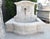 Hand-carved in limestone in Provence, this French wall fountain features an arched back with a similar en chapeau shaped...