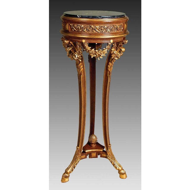 Handcrafted in Italy from solid wood, this elegant plant stand features three gracefully tapered legs adorned with floral...