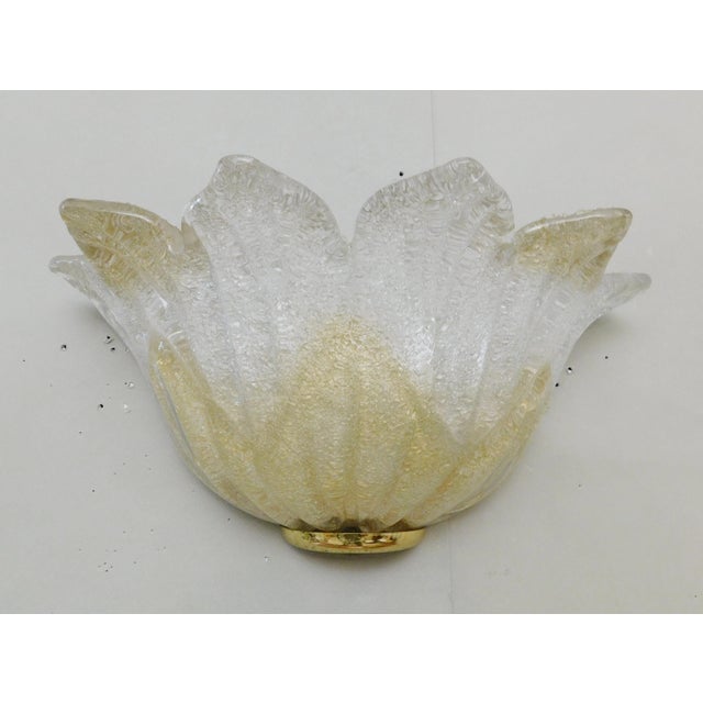 Italian flower shaped wall light with a clear and amber Murano glass shade hand blown in graniglia technique creating...