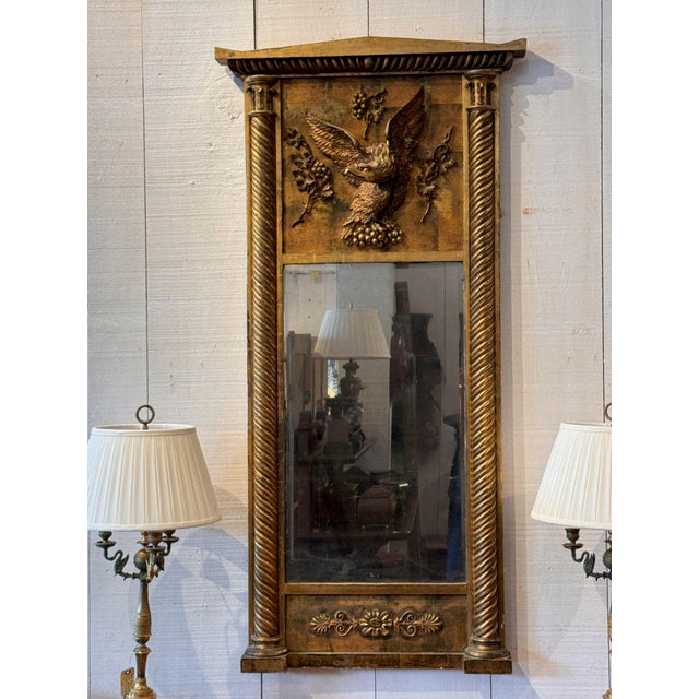 A 19th century giltwood pier mirror, the angular pediment cornice above a rope-twist molding and a tablet mounted with a...