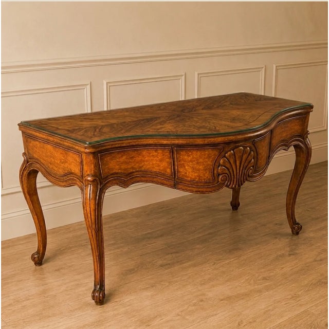 French style (French Country or Louis XV design) console table features a prominent carved shell motif on the central...