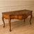 French style (French Country or Louis XV design) console table features a prominent carved shell motif on the central...