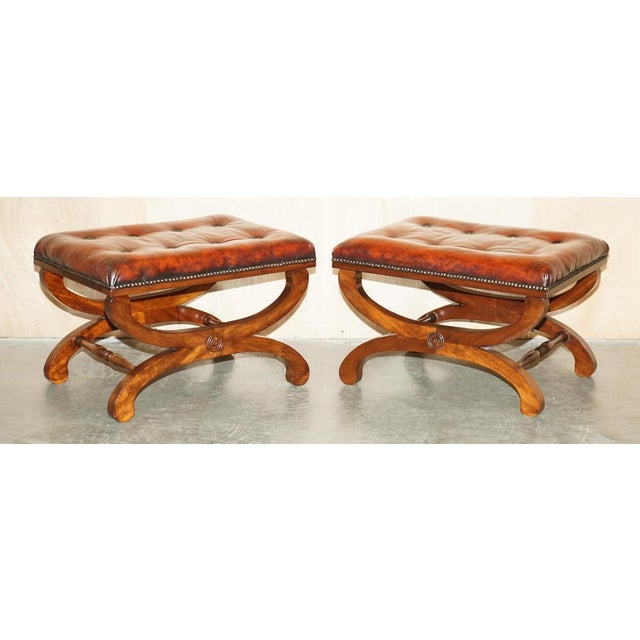 Stunning pair of fully restored hand dyed brown leather Antique Chesterfield footstools with X-Framed Baron bases A very...