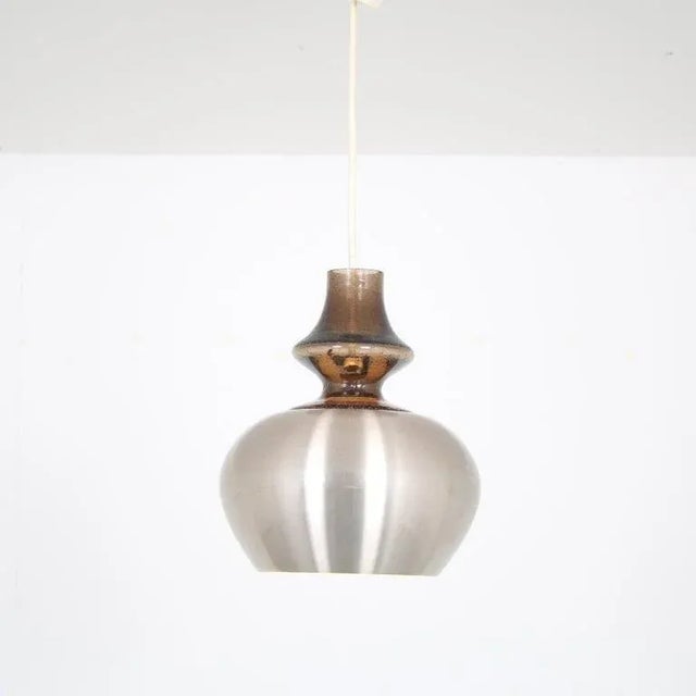 A beautiful hanging lamp, model “carthago”, manufactured by raak in the netherlands around 1970. this elegant piece is...