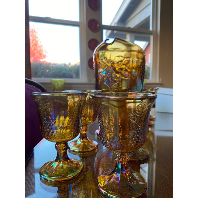 This set features the iconic "Harvest Grape" pattern produced by the Indiana Glass Company, a classic mid-century design...